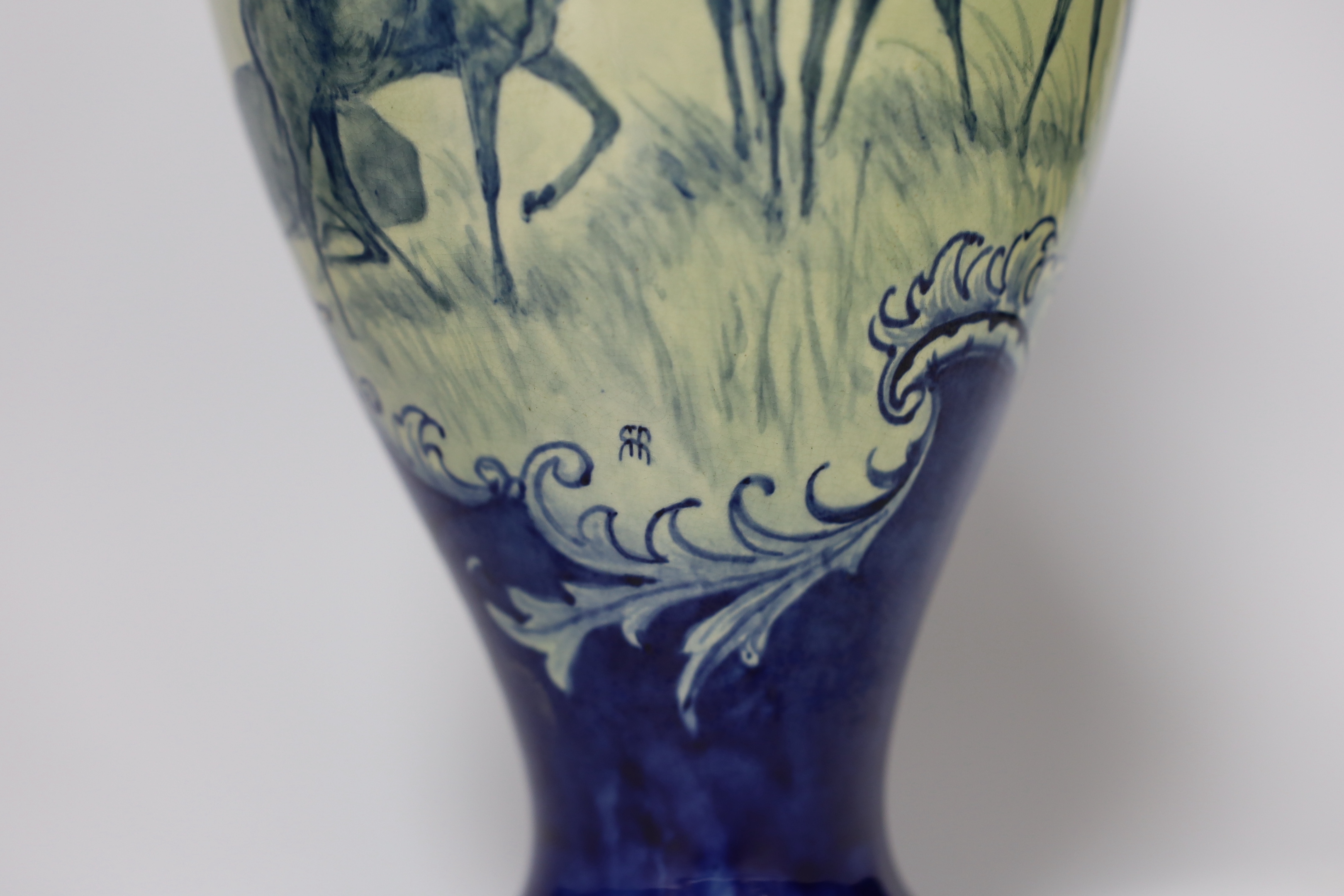 A Doulton Lambeth faience vase, c.1900, attributed to Hannah Barlow, painted with deer in woodland, monogram to the body, and to the base ‘KBS’ for Katherine B. Smallfield, 35cm, high, cf. Bonhams, Knightsbridge, London,